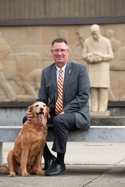 Dean Dan Grooms with his dog Bella