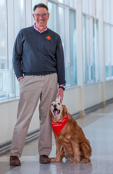 Dean Dan Grooms with his dog Bella